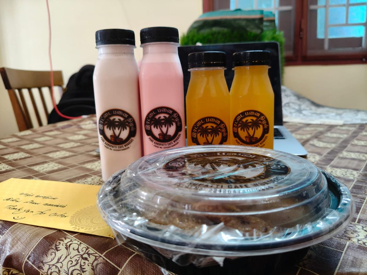 Irattai Panai Nizhal delivery order — rose milk, orange juice bottles with branded snack container and thank you note