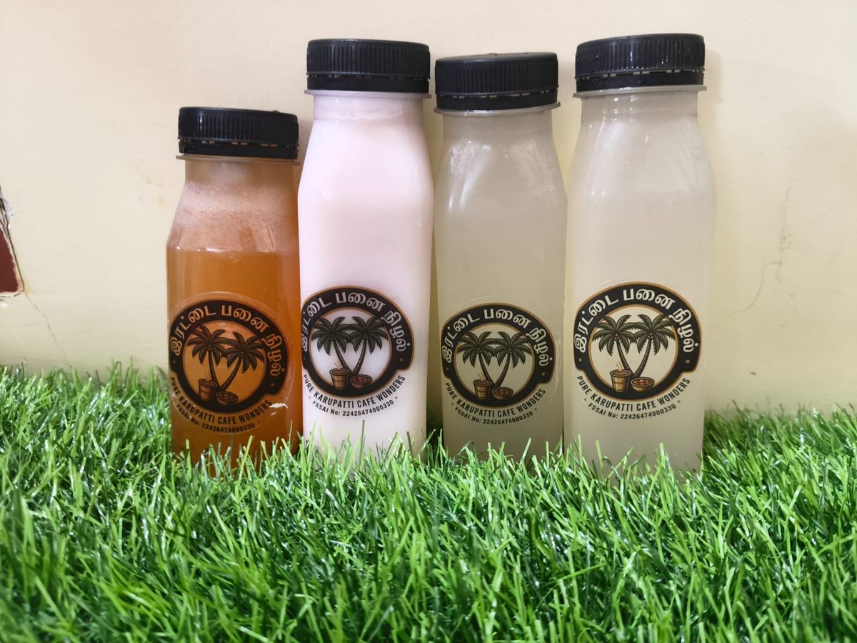 Irattai Panai Nizhal branded bottles on grass — Rose Milk, Nannari Sarbath, and fresh juices
