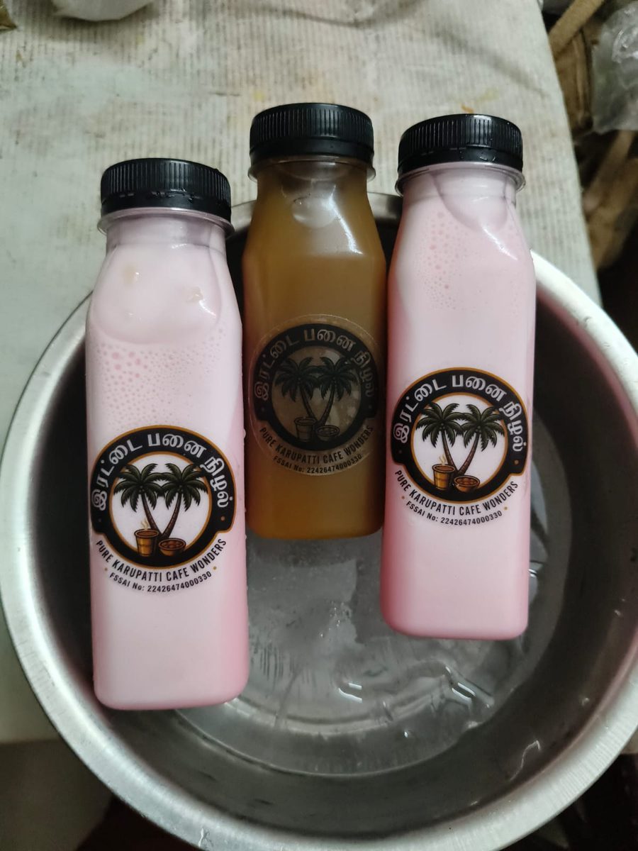 Irattai Panai Nizhal rose milk and karupatti drink bottles chilled in ice water bowl