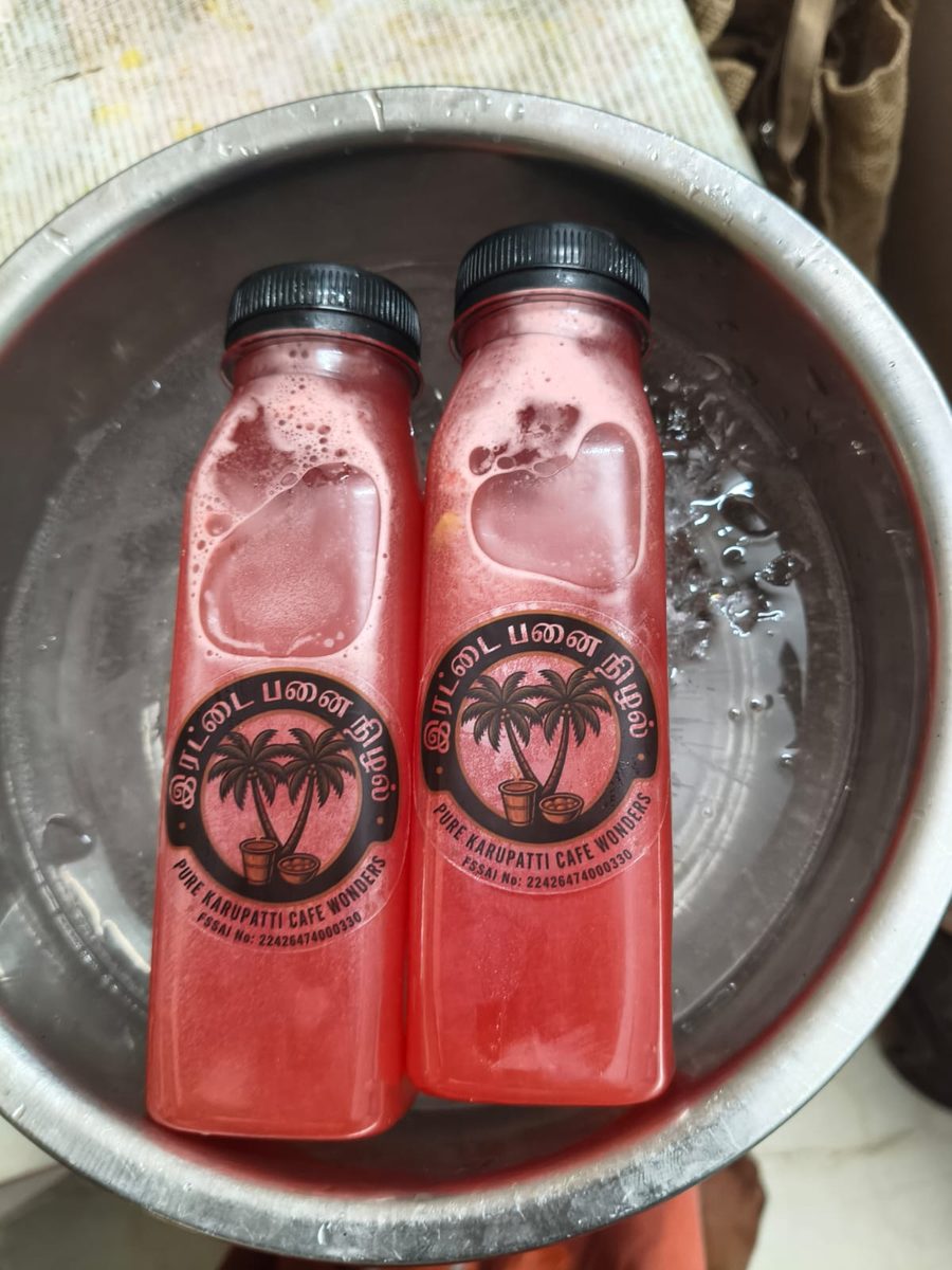 Irattai Panai Nizhal fresh watermelon juice bottles chilled in ice water — vibrant red colour